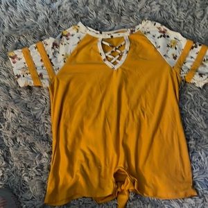 Yellow shirt, floral sleeves, tied in front
